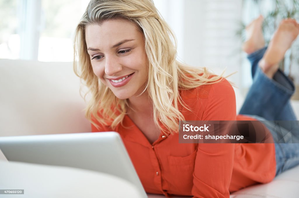 Sofa surfing Full length shot of an attractive young woman using a tablet while relaxing at homehttp://195.154.178.81/DATA/i_collage/pu/shoots/799282.jpg 20-29 Years Stock Photo