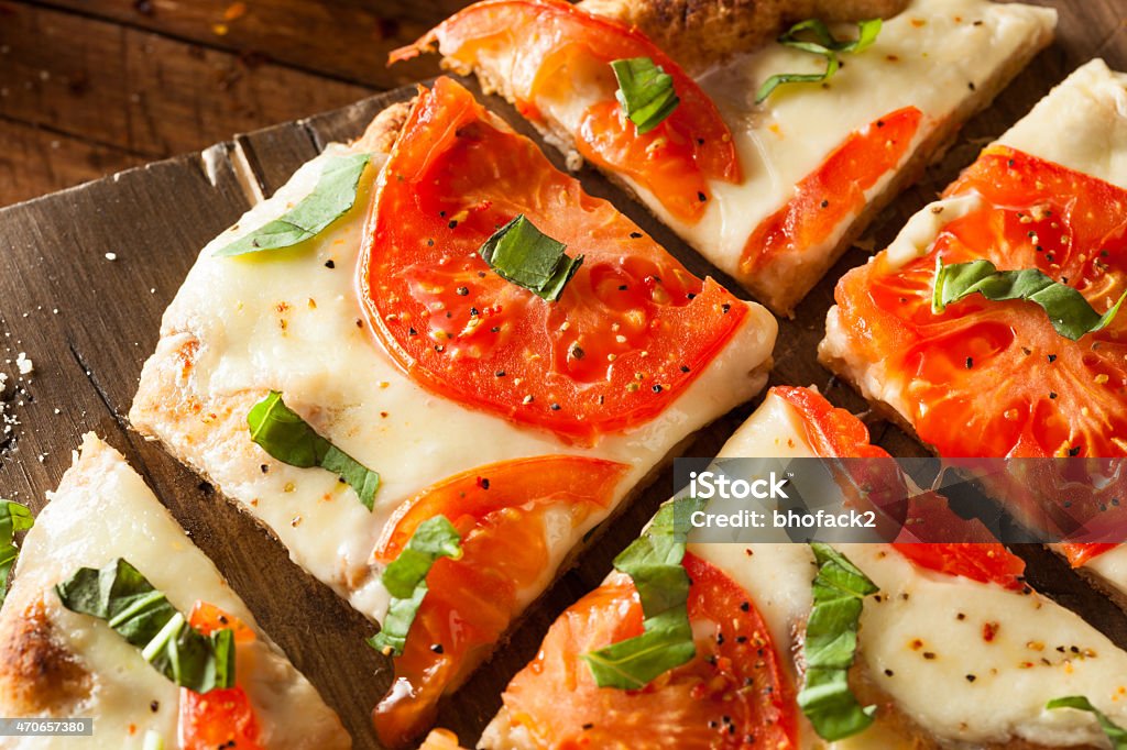 Homemade Margarita Flatbread Pizza Homemade Margarita Flatbread Pizza with Tomato and Basil 2015 Stock Photo
