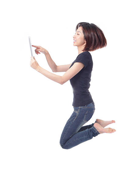 istock beauty  jump and using tablet pc in the air 470658203
