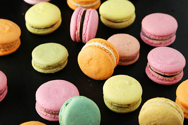 istock French colorful macarons on black background 470661646