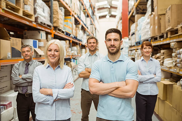 istock Smiling warehouse team with arms crossed 470661850