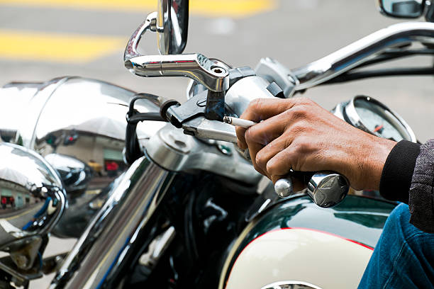 istock hand man ride motorcycle and smoking at the same time 470663960