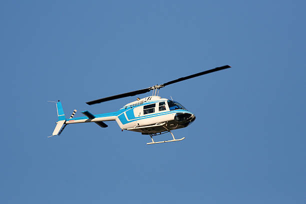 istock Helicopter flying in a natural blue sky background 470668221