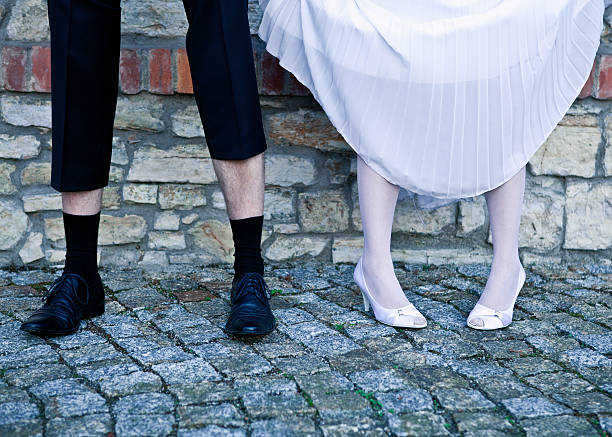 istock Bride and groom standing agains the wall 470668474