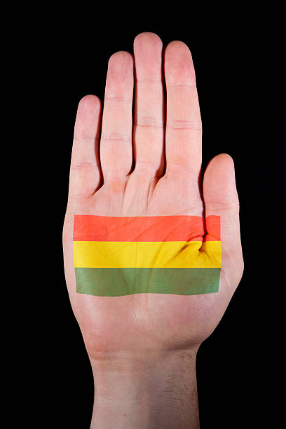 A macro shot of a human male hand, with a stencil of a flag, shot under studio conditions. 