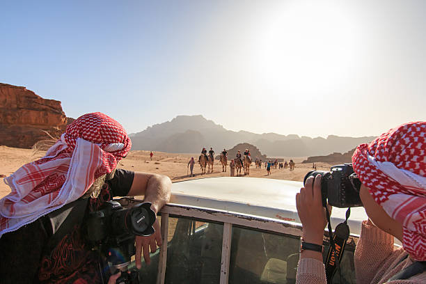 Tourists taking pictures in the Wadi Rum desert, Jordan stock photo
