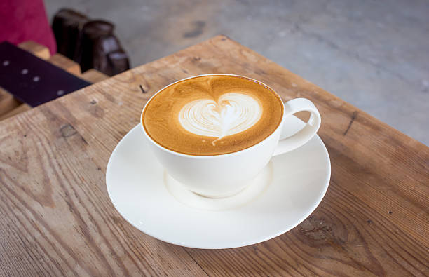 istock Coffee latte cup with milk on the table 470673178