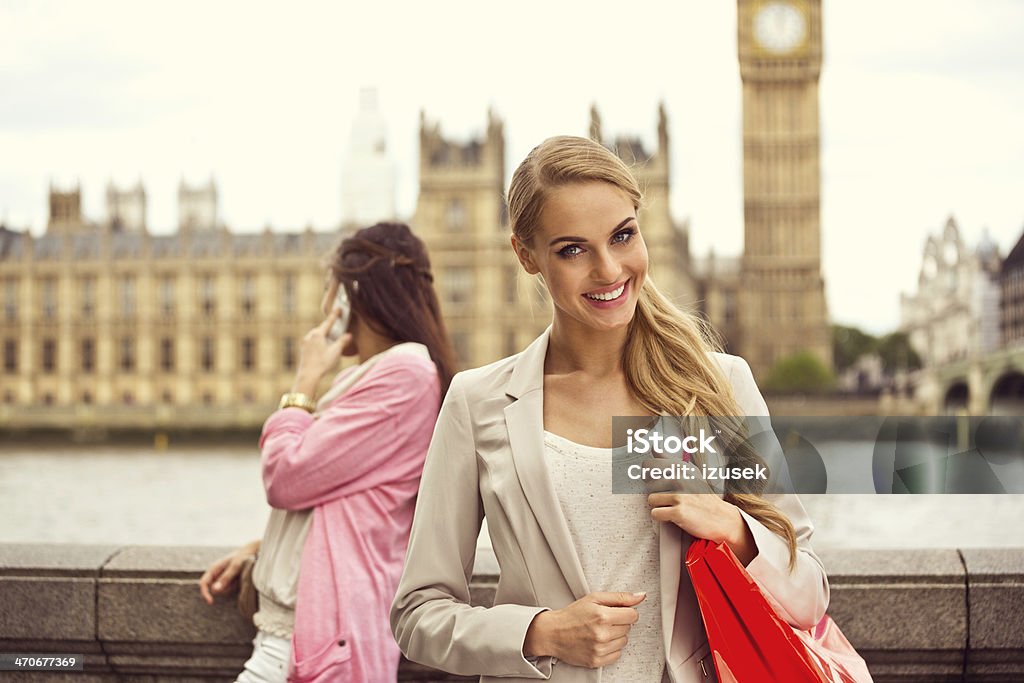 London tourist Outdoor portrait of happy young woman smiling at camera with Houses of Parliament and Big Ben in the background. 20-24 Years Stock Photo