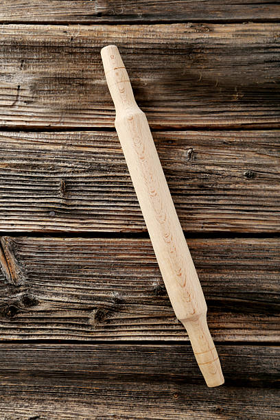 istock Rolling pin on brown wooden background 470678234