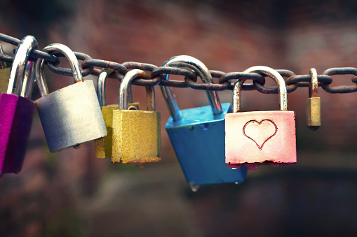 Bridge with love locks over the Venice water canal, Italy