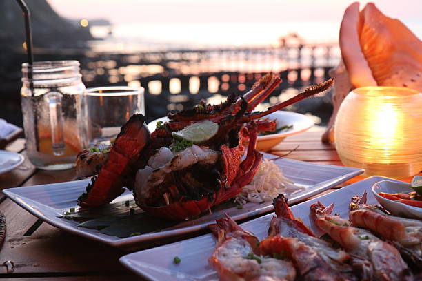 Lobster dinner Beachside dining with lobster dinner lobster seafood photos stock pictures, royalty-free photos & images