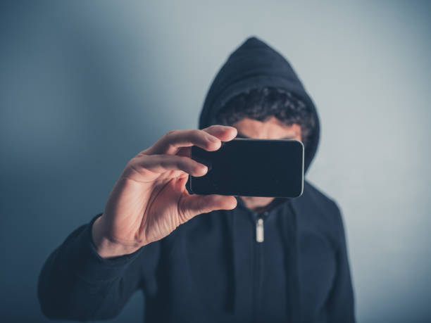istock Man in hooded top taking photos 470681690