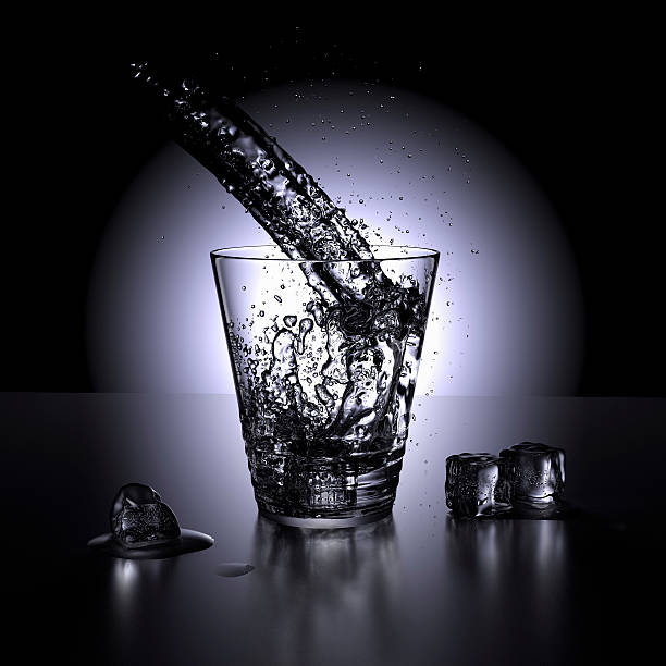 Water splashing in a glass of water stock photo