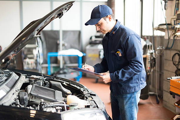 istock Mechanic in blue uniform working on a car 470691444