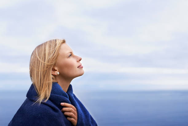 Loneliness. Rear view portrait of a woman at the coast