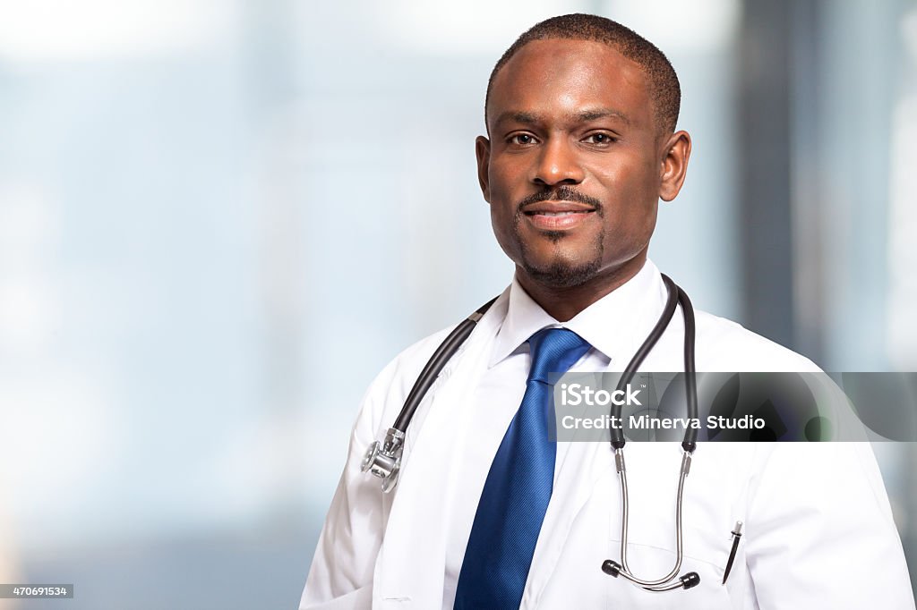 Portrait of a smiling African American male doctor Portrait of an handsome smiling doctor Blue Stock Photo