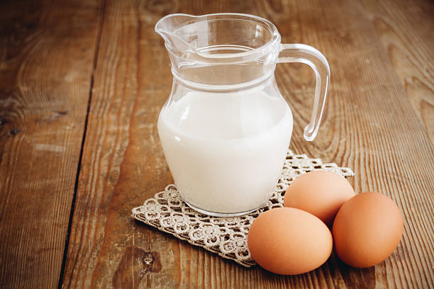 istock milk in jug and eggs on wooden surface 470692492
