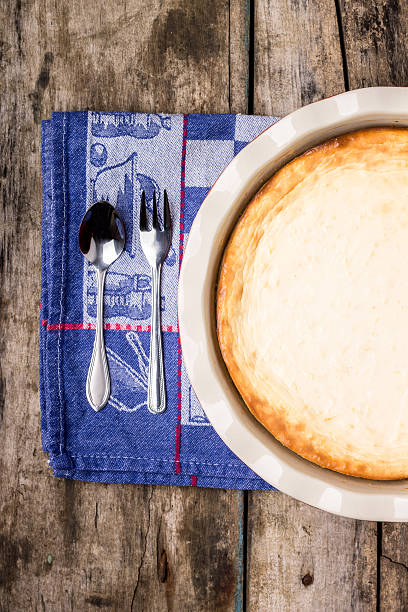 Fresh baked cheesecake on wooden table.