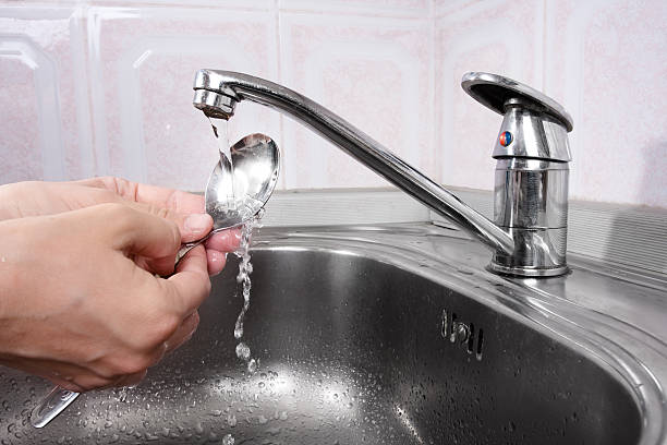 istock Women's hands washing the spoon 470695632