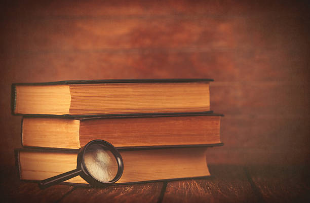 istock Books with loupe on wooden background. 470697654