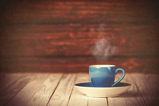 istock Cup of coffee on wooden table and background. 470697658