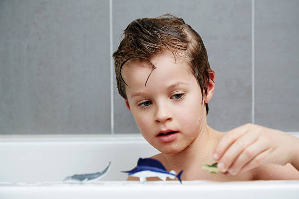istock Boy with toys in bath 470697842