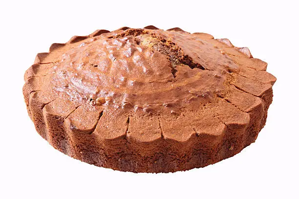 Non glazed "Zebra" cake with large crack in the center isolated over background. Side view.