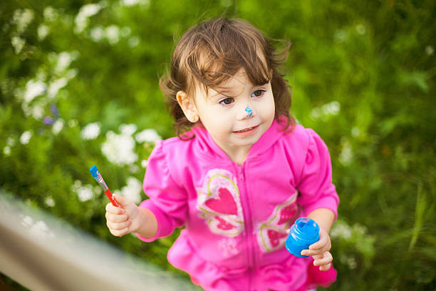 child painting hands outside