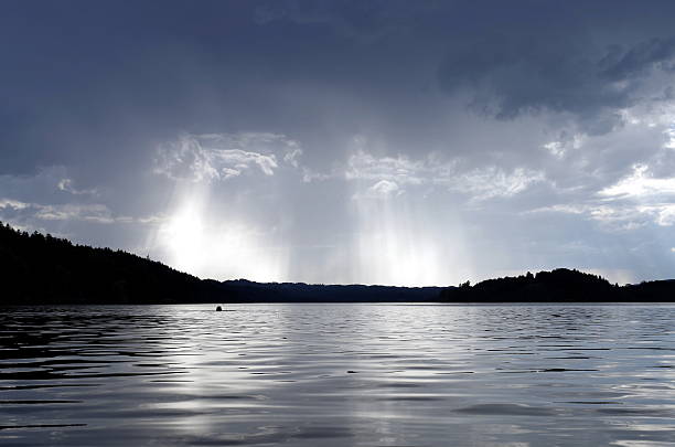 Lake before the storm Last swim before the storm, dark clouds over the lake Staffelsee, near Murnau, Bavaria lake staffelsee photos stock pictures, royalty-free photos & images