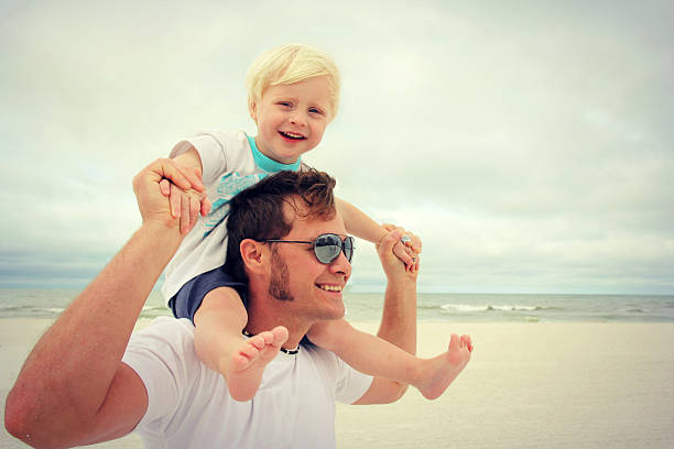 istock Father and Son Playing on Beach by Ocean 470700814