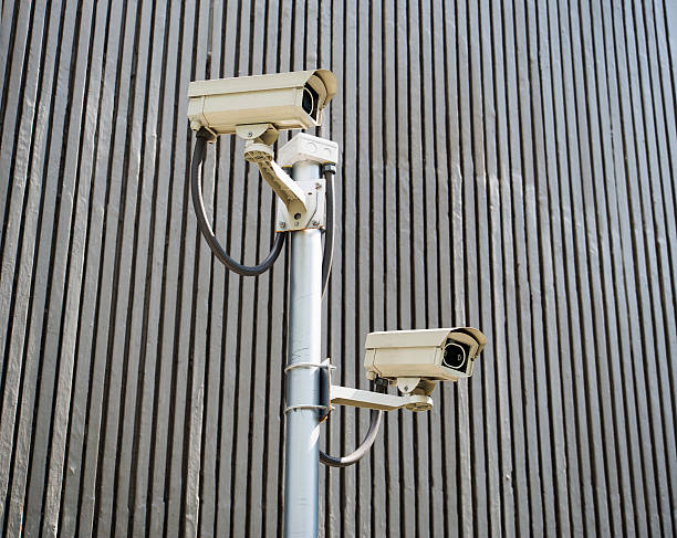 istock cctv installed on the wall on window glass of building 470702816