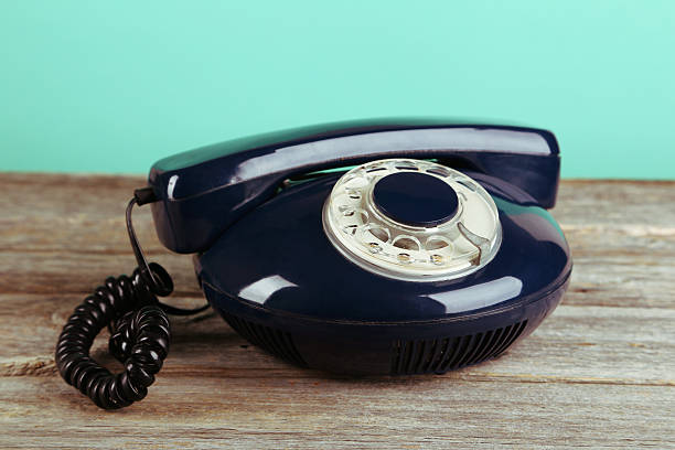 istock Old retro phone on grey wooden background.Toning 470705966
