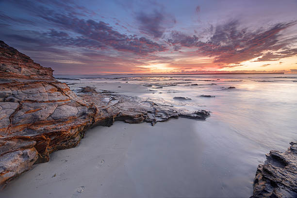 Dawn skies at Plantation Point Jervis Bay Australia Beautiful pastel colours of the dawn sky and the subtle light on the textured sandstone rocks and water. shoalhaven photos stock pictures, royalty-free photos & images