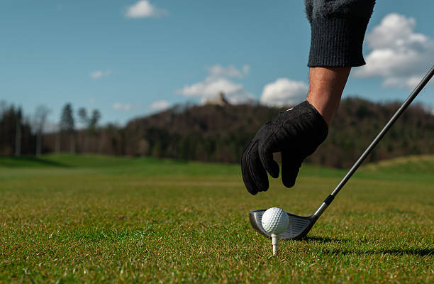 istock hand placing a tee with golf ball 470711422