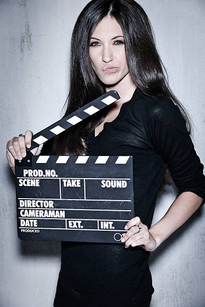 istock Beautiful woman holding clapperboard 470715733