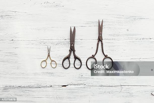 Three Scissors On White Wooden Table Stock Photo - Download Image Now - 2015, Art And Craft, Close-up