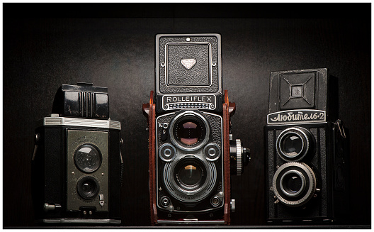 Vancouver, Canada - March 15, 2015: Twin lens reflex (TLR) style vintage film cameras on display. Cameras include a Kodak Brownie Reflex, Rolleiflex 3.5F and soviet-made Lubitel-2.