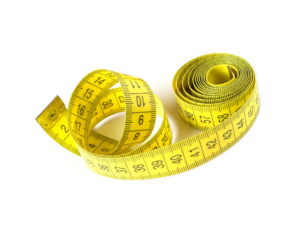 istock Yellow measuring tape isolated on white closeup 470721556