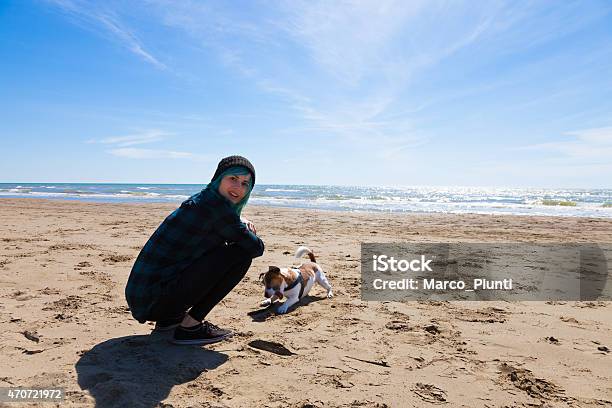 Girl At Sea With Dog Stock Photo - Download Image Now - 2015, Adult, Beach