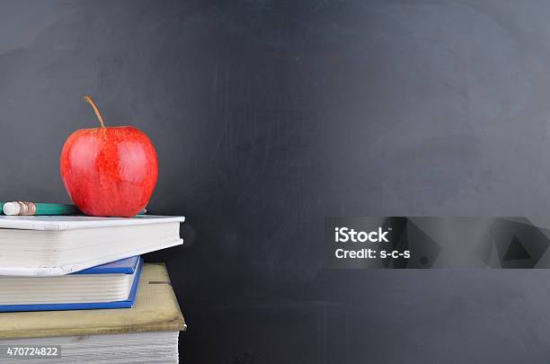 Classroom Concept With Books An Apple And Blackboard With Handwriting Stock Photo - Download Image Now