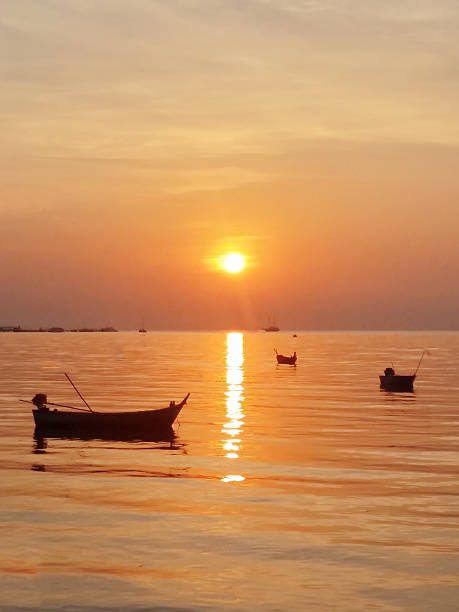 istock Sunset over the Sea with Silhouette Boats 470725272