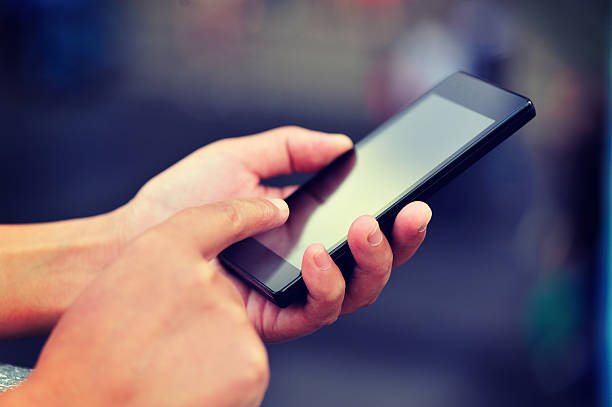 istock hands use smart phone at city 470725386