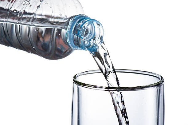 istock Hand holding bottle water and pouring 470726701