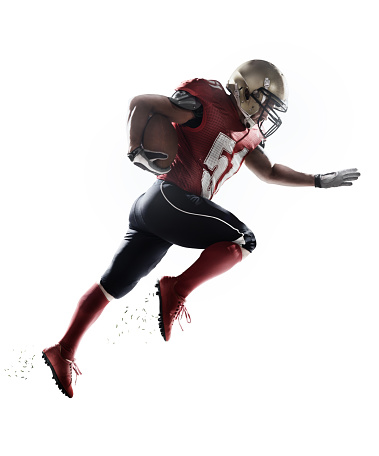 A male isolated american football player makes a dramatic play on white background.