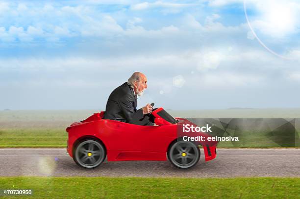 Senior Man Driving A Toy Racing Car Stock Photo - Download Image Now - Humor, Car, Senior Men