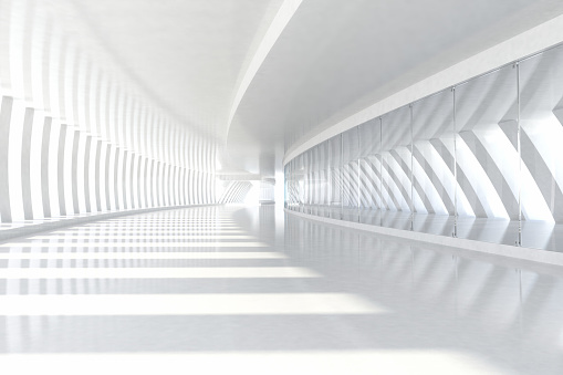 Empty space with rows of white columns forming a long corridor with sunlight illuminating the wide architectural space, casting shadows and a light pattern on the floor. White glossy material reflecting the three-dimensional elements gives the scene a modern and futuristic style. Wideangle view. Copy space.