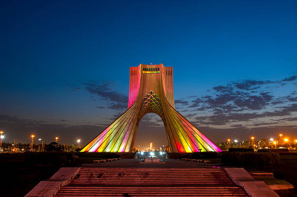Photo of the Azadi Tower in Iran lit up at night Azadi Tower, also called Freedom Tower, or Liberty Tower, is one of the landmarks in Tehran, Iran tehran stock pictures, royalty-free photos & images