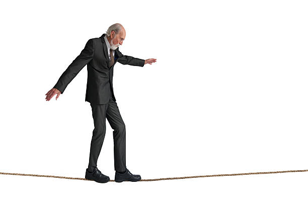 uomo anziano camminare una corda da acrobata - tightrope balance walking rope foto e immagini stock