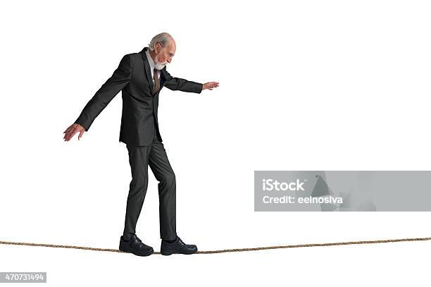 Senior Man Walking A Tightrope Stock Photo - Download Image Now - Tightrope, Cut Out, Senior Adult