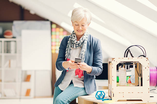 istock Mature Woman Working By 3D Printer in New Startup Office. 470731556
